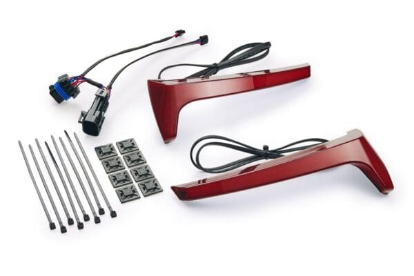 A pair of red mirrors and wires are next to each other.