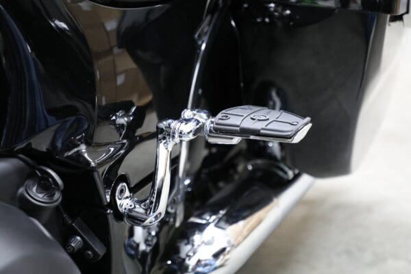 A close up of the foot rest on a motorcycle